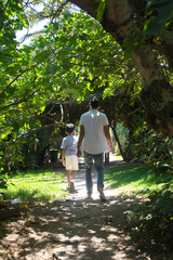 father and son stroll in the garden