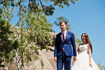 Lovely wedding couple at amazing landscapes with rock Dovbush, Carpathian mountains at Ukraine.