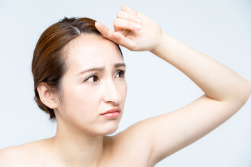 Naklejka premium middle aged woman who checks her skin. acne treatment.