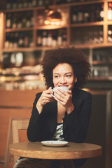 Mixed race woman taking a break in cafeteria while sitting
