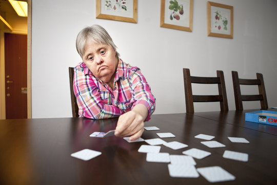 Senior woman playing memory game at home