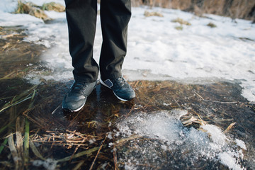 man stay on the cracked ice on the lake