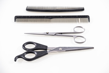 Hair cutting shears and comb isolated on white