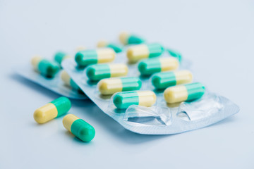 Pile of scattered capsules on a white background