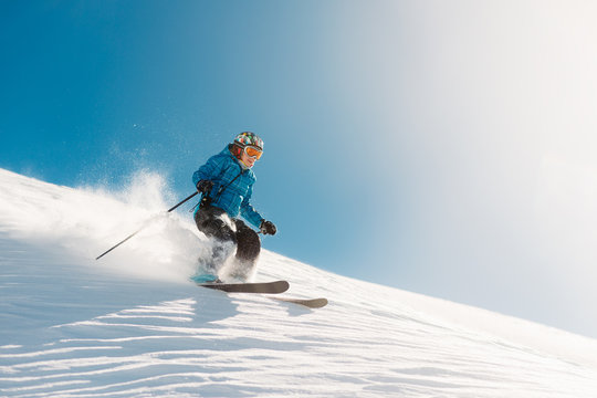 girl with special ski equipment is riding very fast in the mountain hill