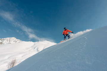 Fototapeta na wymiar snowboarder is riding from snow hill