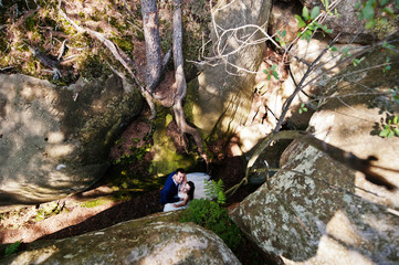 Lovely wedding couple at amazing landscapes with rock Dovbush, Carpathian mountains at Ukraine.