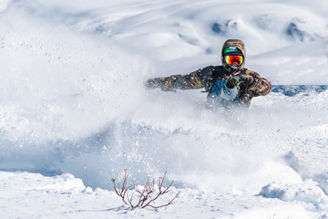 snowboarder is riding from snow hill