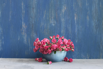 Bouquet of crimson roses on blue