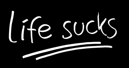 Life sucks symbol on blackboard