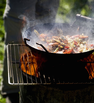 Vegetables in wok on gill