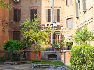 Italian courtyard. Patio with roses, Rome, Italy  
