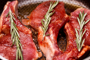 Steaks meat fried in a pan. Close-up. 