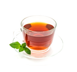 Isolated transparent cup of black tea with mint leaf on white