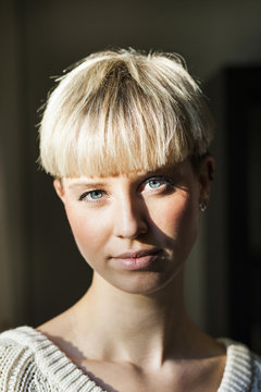 Portrait of confident young woman with short blond hair