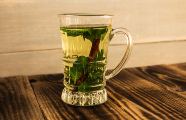 clear cup with mint and cinnamon stick tea