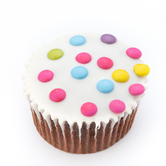 Multiple colorful decorated muffins on a white background.