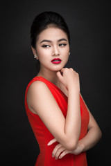 Closeup of beautiful sexy girl with bright makeup and red lips. Beauty fashion asian woman.