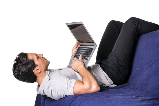 Young man working with computer on couch