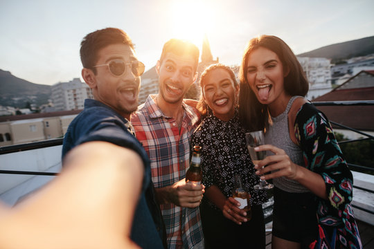 Group of people making a selfie at party