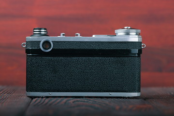 The old Soviet rangefinder camera n the wooden background.