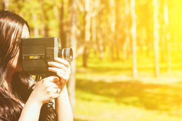 Woman with vintage video camera outdoor