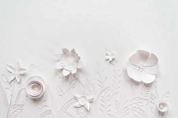 Summer flowering meadow. White flowers carved from paper on a white background
