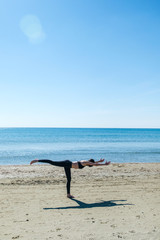 Caucasian woman practicing yoga at black sea