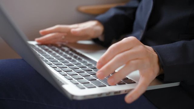 Neat Hands of a Young Nice Business Lady are Typing Text on a Laptop during the Journey by Train