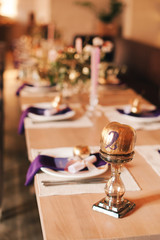 the numbering of the table on a wooden stand with fruits in gold paint