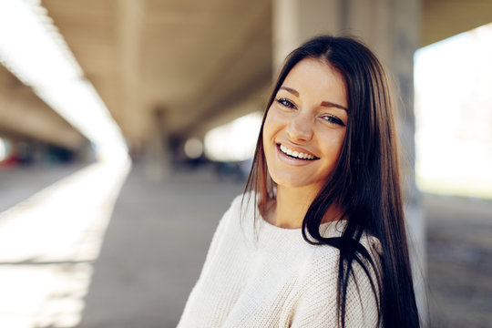 Portrait of a young woman with a beautiful smile on her face