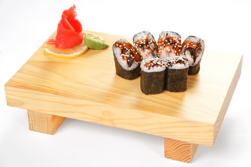 Traditional Japanese cuisine, sets of sushi and rolls on a wooden stand