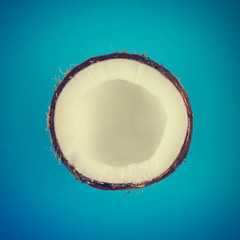 Coconut close up on blue background. Minimal summer concept. Flat lay.