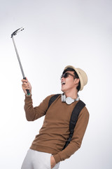 Happy young asian man taking self portrait photography through smart phone