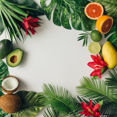 Creative layout made of summer tropical fruits and leaves. Flat lay. Food concept.