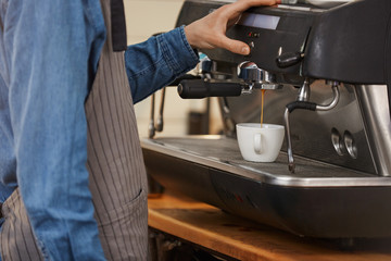 Professional coffee machine. Closeup of bartender making coffee drink.