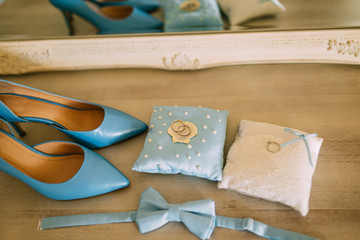 Wedding shoes of a bride on a stone background and a blue bridal bouquet. Wedding in Montenegro.