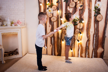 Fototapeta na wymiar Little boy and girl play LED bulbs. They are holding light bulbs