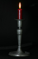 red candle in old tin candlestick