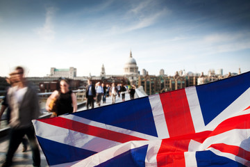 union jack flag and people walking on Millenium bridge in the background, London - UK prepares for...