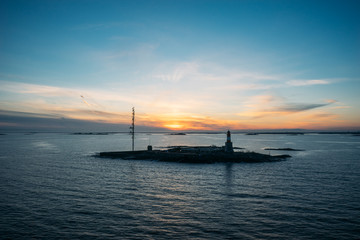 Small island with lighthouse and communication tower