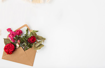 Love or valentine's day concept. Red beautiful roses in envelopen