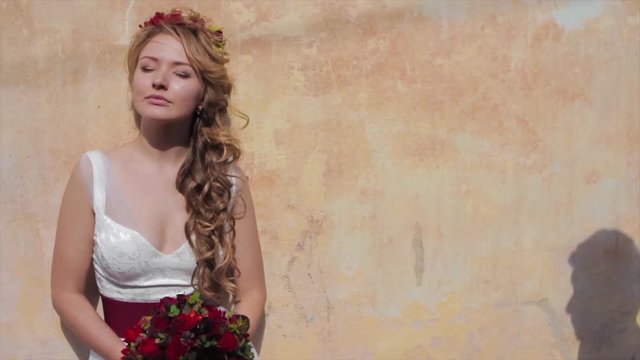 Bride and Groom Standing by Old Wall in Sun. Slowmotion