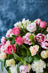 Flower arrangement with tulips and ranunculus on a white wooden floor. Spring flower 