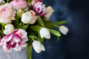 Obraz na płótnie Canvas Flower arrangement with tulips and ranunculus on a white wooden floor. Spring flower 