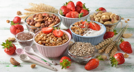 Muesli, nuts, yogurt and cereals on a white background