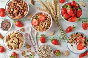 Muesli, nuts, yogurt and cereals on a white background
