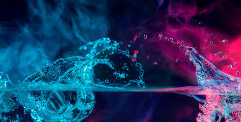 colorful splashes with smoke over water surface