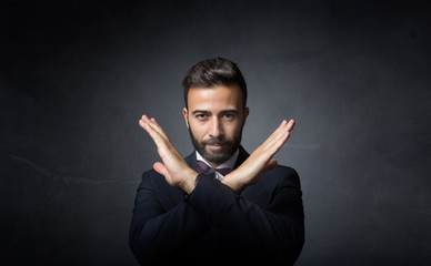 elegant man gesturing x with hands