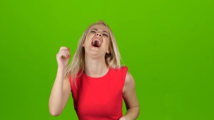 Girl in red dress is dancing for joy, green screen - Powered by Adobe